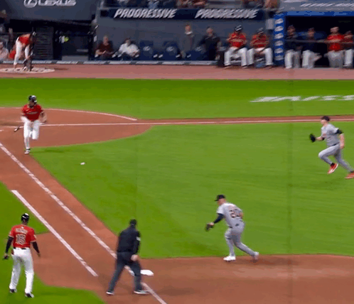A Baseball Game Is Being Played In Front Of A Banner That Says Progressive GIF