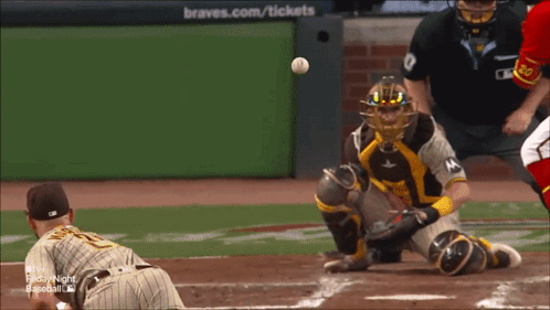 A Baseball Game Is Being Played In Front Of A Braves.com / Tickets Sign GIF