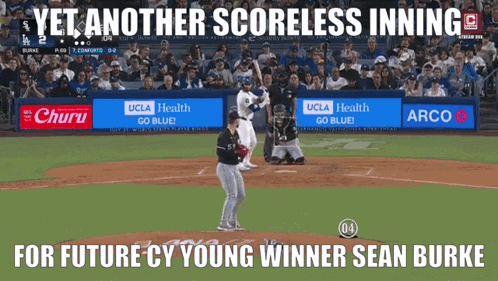 A Baseball Game Is Being Played In Front Of A Crowd And A Sign That Says Yet Another Scoreless Inning GIF