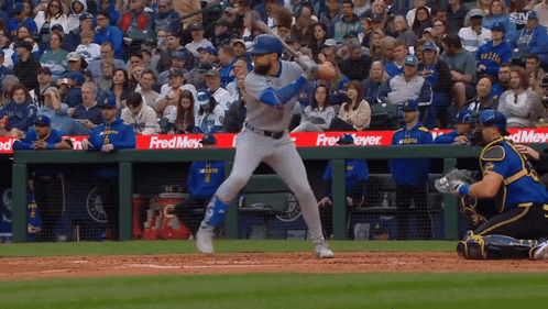 A Baseball Game Is Being Played In Front Of A Crowd With A Fred Meyer Sign In The Outfield GIF