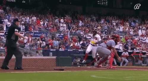 A Baseball Game Is Being Played In Front Of A Crowd With A Hyundai Sign In The Stands GIF