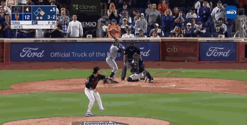 A Baseball Game Is Being Played In Front Of A Crowd With Ford Advertisements GIF