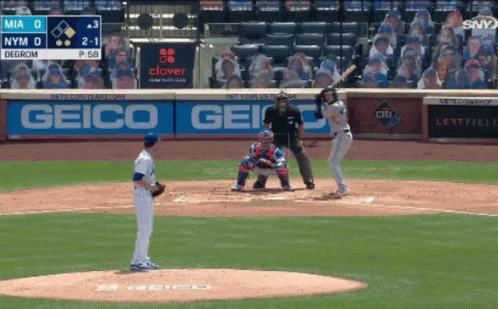 A Baseball Game Is Being Played In Front Of A Geico Ad GIF