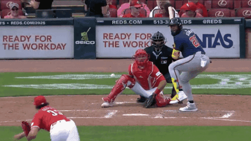 A Baseball Game Is Being Played In Front Of A Geico Sign GIF