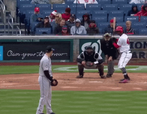 A Baseball Game Is Being Played In Front Of A Nationals.com Sign GIF