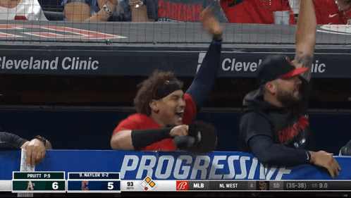 A Baseball Game Is Being Played In Front Of A Progressive Banner GIF