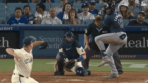 A Baseball Game Is Being Played In Front Of A Security Health Ad GIF