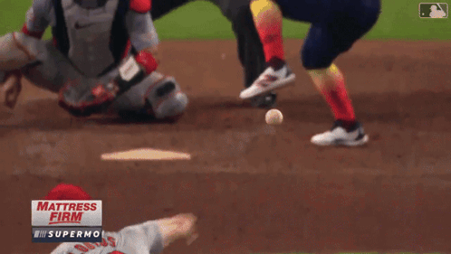 A Baseball Game Is Being Played In Front Of A Sign That Says " Mattress Firm " GIF