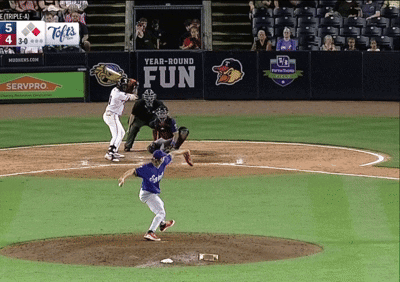 a baseball game is being played in front of a sign that says " year-round fun "