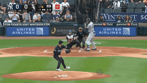 A Baseball Game Is Being Played In Front Of A United Airlines Sign GIF