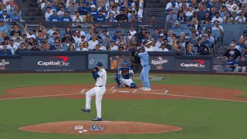 A Baseball Game Is Being Played In Front Of A Wall That Says Capital One On It GIF