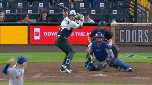 A Baseball Game Is Being Played In Front Of An Ad For Coors Beer GIF