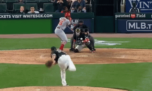A Baseball Game Is Being Played In Front Of An Ad For Mlb GIF