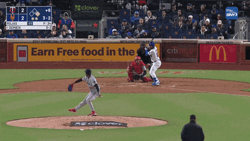 A Baseball Game Is Being Played In Front Of An Earn Free Food In The Mcdonald 'S Sign GIF