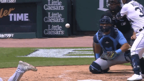 A Baseball Game Is Being Played In Front Of Signs For Little Caesars GIF