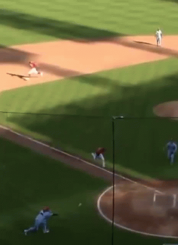 A Baseball Game Is Being Played On A Field With A Few Players On It GIF