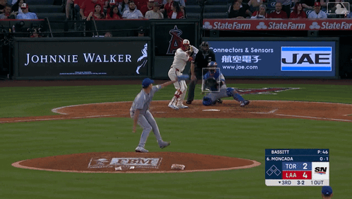 A Baseball Game Is Being Played With An Ad For Johnnie Walker GIF
