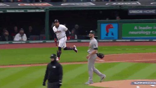 A Baseball Game Is Underway With A Banner That Says A Leader In Neurology On It GIF