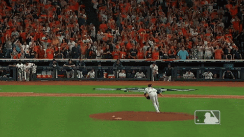 A Baseball Pitcher Is About To Throw The Ball In Front Of A Crowd That Is Cheering GIF