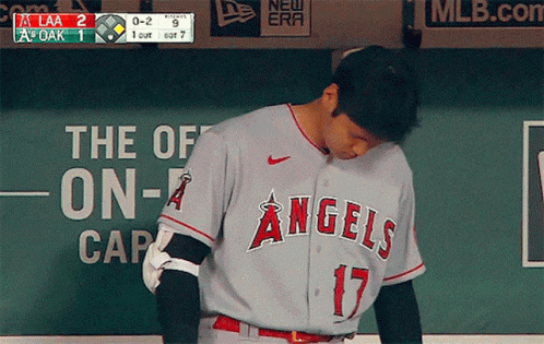 A Baseball Player For The Angels Looks Down At Something GIF