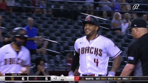 A Baseball Player For The Arizona Bricks Is Smiling And Talking To A Referee GIF