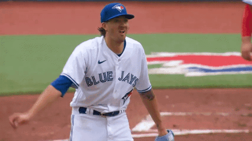 A Baseball Player For The Blue Jays Is Standing On A Field GIF