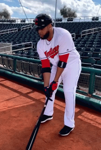 A Baseball Player For The Indians Holds A Bat GIF