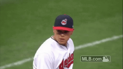A Baseball Player For The Indians Is Throwing A Baseball GIF