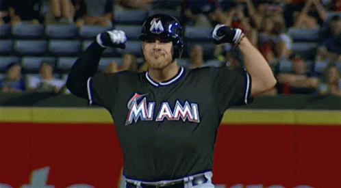 A Baseball Player For The Miami Marlins Is Flexing His Muscles GIF