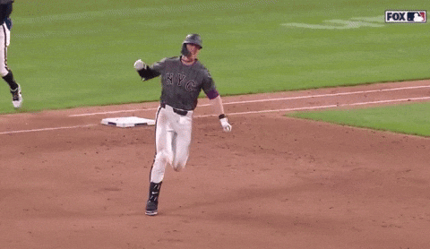 A Baseball Player For The Ny Yankees Is Running On A Field GIF