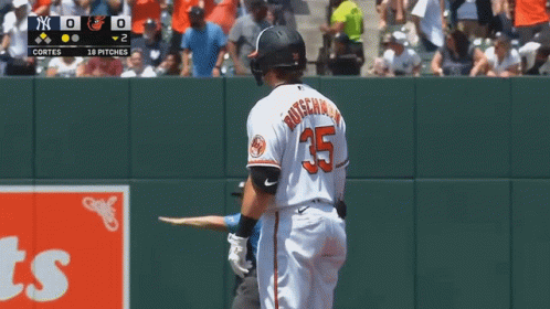 A Baseball Player For The Orioles Is Standing On The Field GIF
