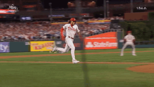 A Baseball Player For The Phillies Is Running Towards Home Plate GIF