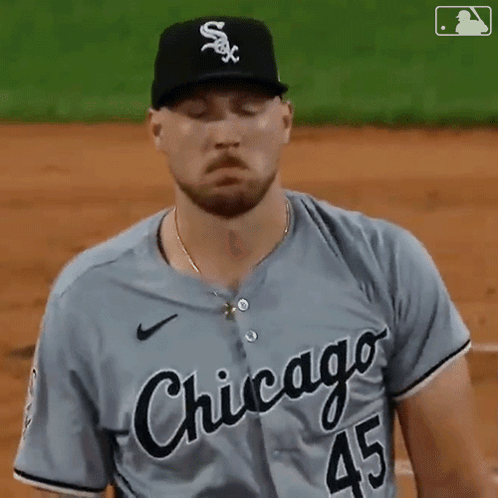 A Baseball Player From The Chicago White Sox Is Standing On The Field With His Eyes Closed GIF