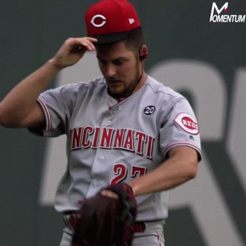 A Baseball Player From The Cincinnati Reds Adjusts His Cap GIF