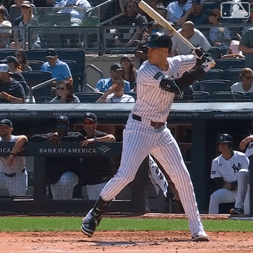 A Baseball Player Getting Ready To Bat In Front Of A Bank Of America Advertisement GIF