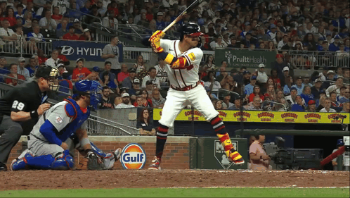 a baseball player getting ready to bat with a gulf sign in the outfield