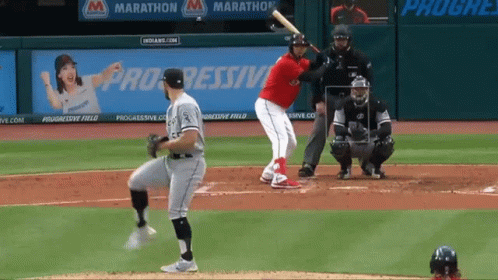 A Baseball Player Getting Ready To Hit A Ball With Progressive Field Advertisements In The Background GIF