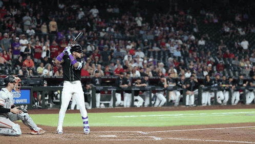 A Baseball Player Getting Ready To Hit The Ball In Front Of A Sign That Says Chase GIF