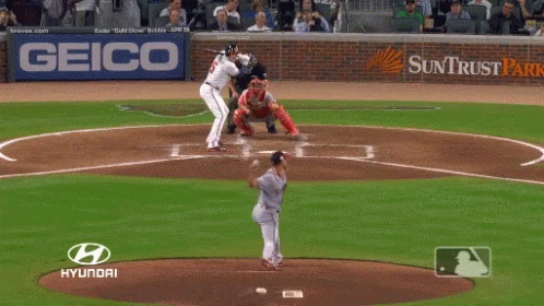 A Baseball Player Getting Ready To Hit The Ball With A Hyundai Logo Behind Him GIF