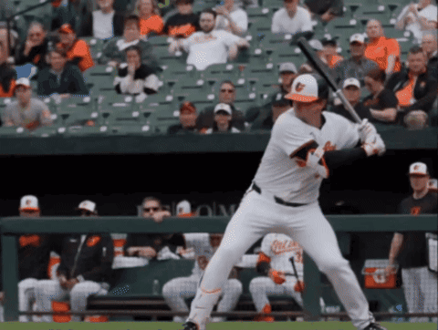 A Baseball Player Getting Ready To Swing At A Ball In Front Of A Crowd GIF