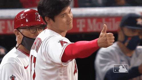 A Baseball Player Giving A Thumbs Up In Front Of A T Mobile Banner GIF