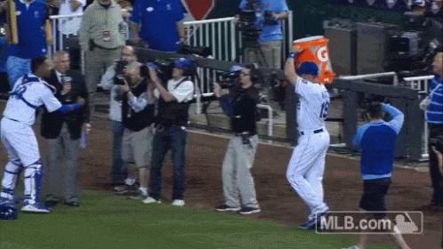 A Baseball Player Holding A Gatorade Bucket In His Hand GIF
