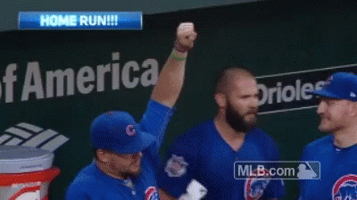 A Baseball Player Holds Up His Fist In The Air In Front Of A Bank Of America Sign GIF