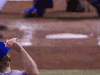 A Baseball Player In A Blue Hat Is Looking At The Bases GIF