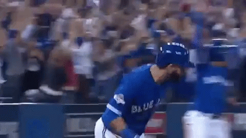 A Baseball Player In A Blue Uniform Is Hugging Another Player On A Baseball Field . GIF