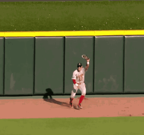 a baseball player in a boston uniform is running on the field