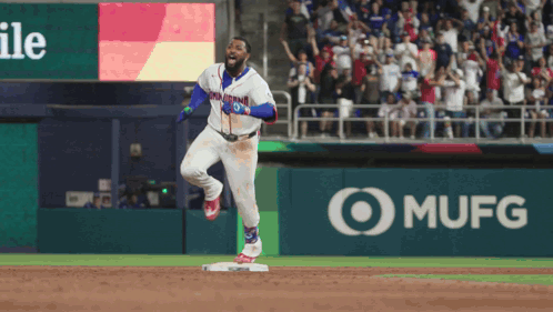 A Baseball Player In A Dominican Jersey Is Running Towards Home Plate GIF