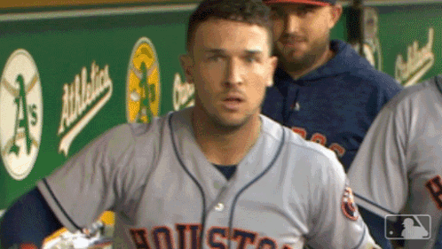 A Baseball Player In A Houston Jersey Stands In The Dugout GIF