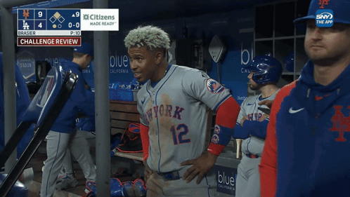 A Baseball Player In A New York Jersey Stands In The Dugout GIF