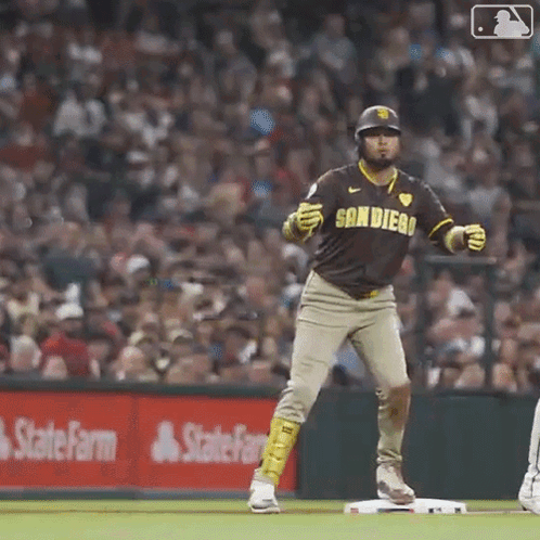 A Baseball Player In A San Diego Uniform Is Standing On The Base . GIF